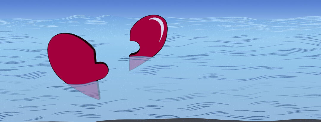 a heart shaped puzzle broken in half floating in the ocean