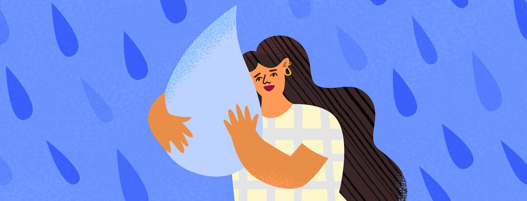 Woman hugging a giant tear drop, crying